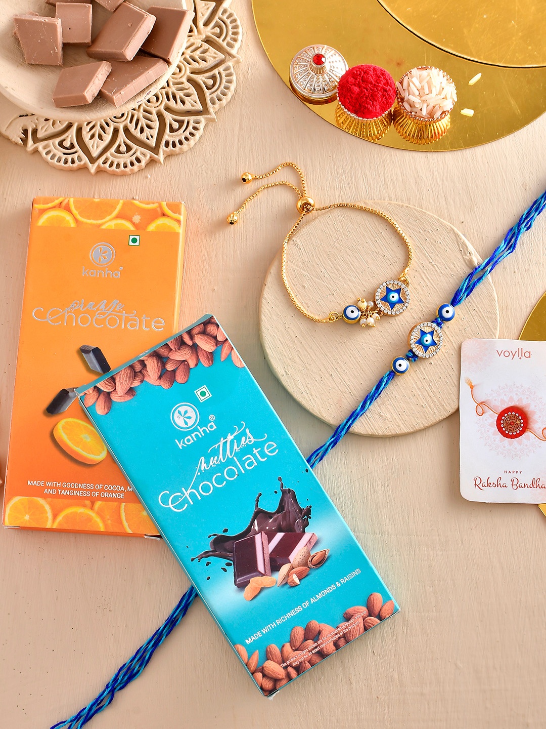 

Voylla Set Of 4 Rakhis with Orange And Nutty Chocolate Bar, Blue