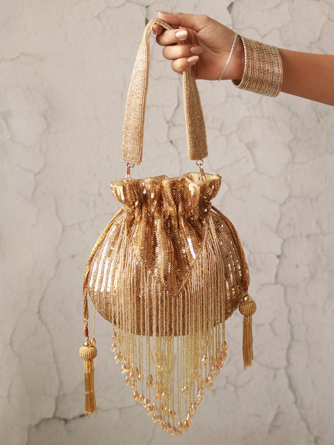 

THE TAN CLAN Embellished Tasselled Potli Clutch, Gold