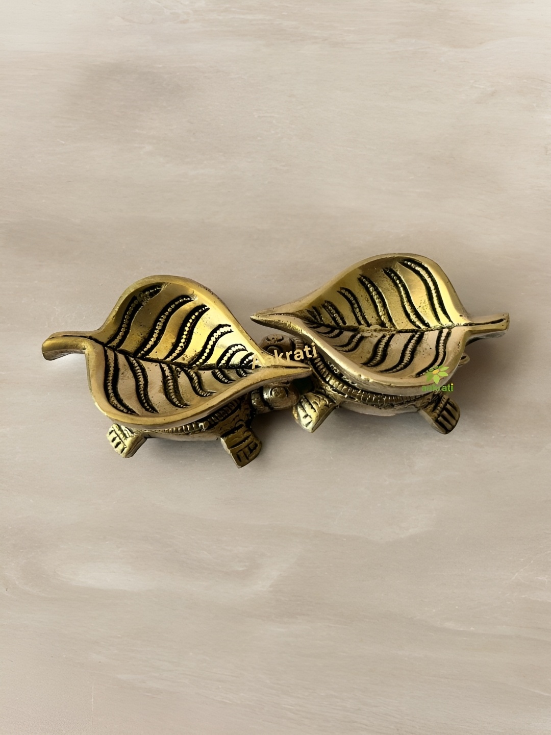 

Aakrati Yellow & Black Textured Brass Pooja Essentials