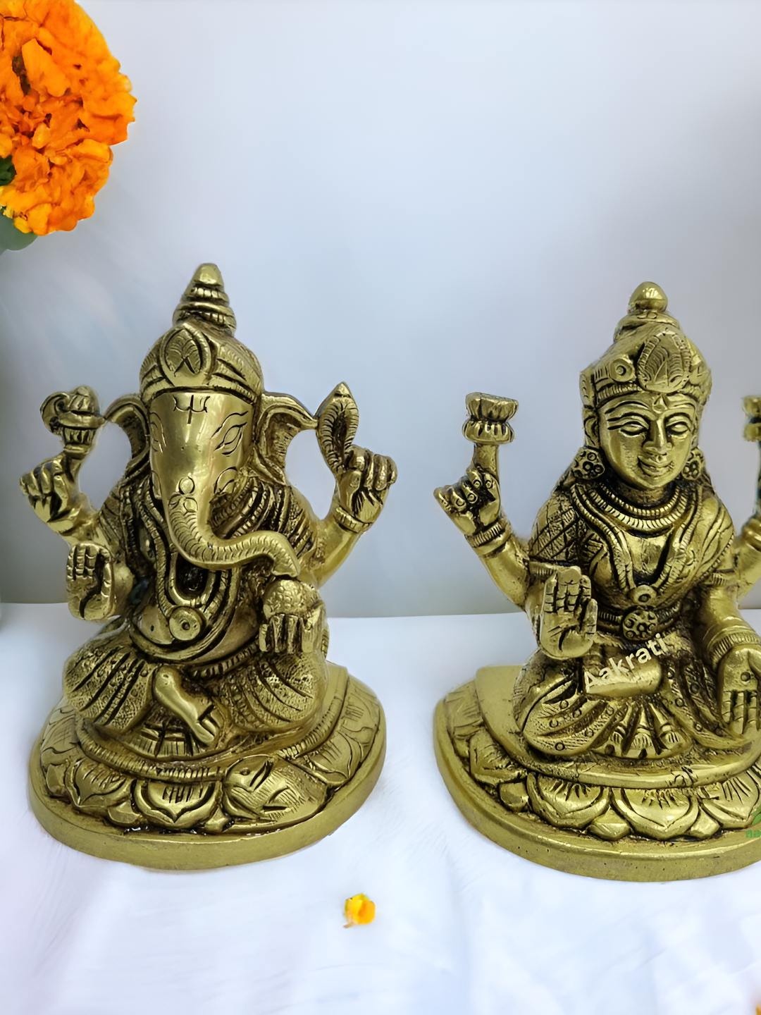 

Aakrati Yellow & Black Brass Religious Lakshmi Ganesha Idol Showpiece