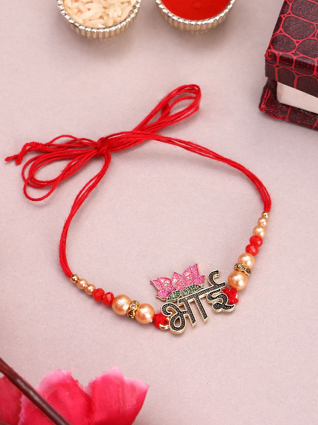 

PANASH Gold-Plated Name of Bhai With Lotus Shaped Thread Rakhi With Roli Chawal
