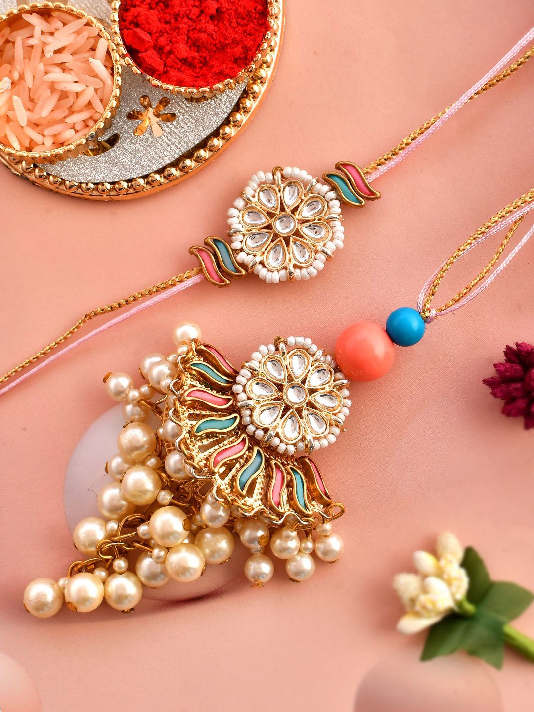 

Aapno Rajasthan Kundan & Pearl Beaded Bhaiya Bhabhi Rakhi With Roli Chawal & Greeting Card, Pink