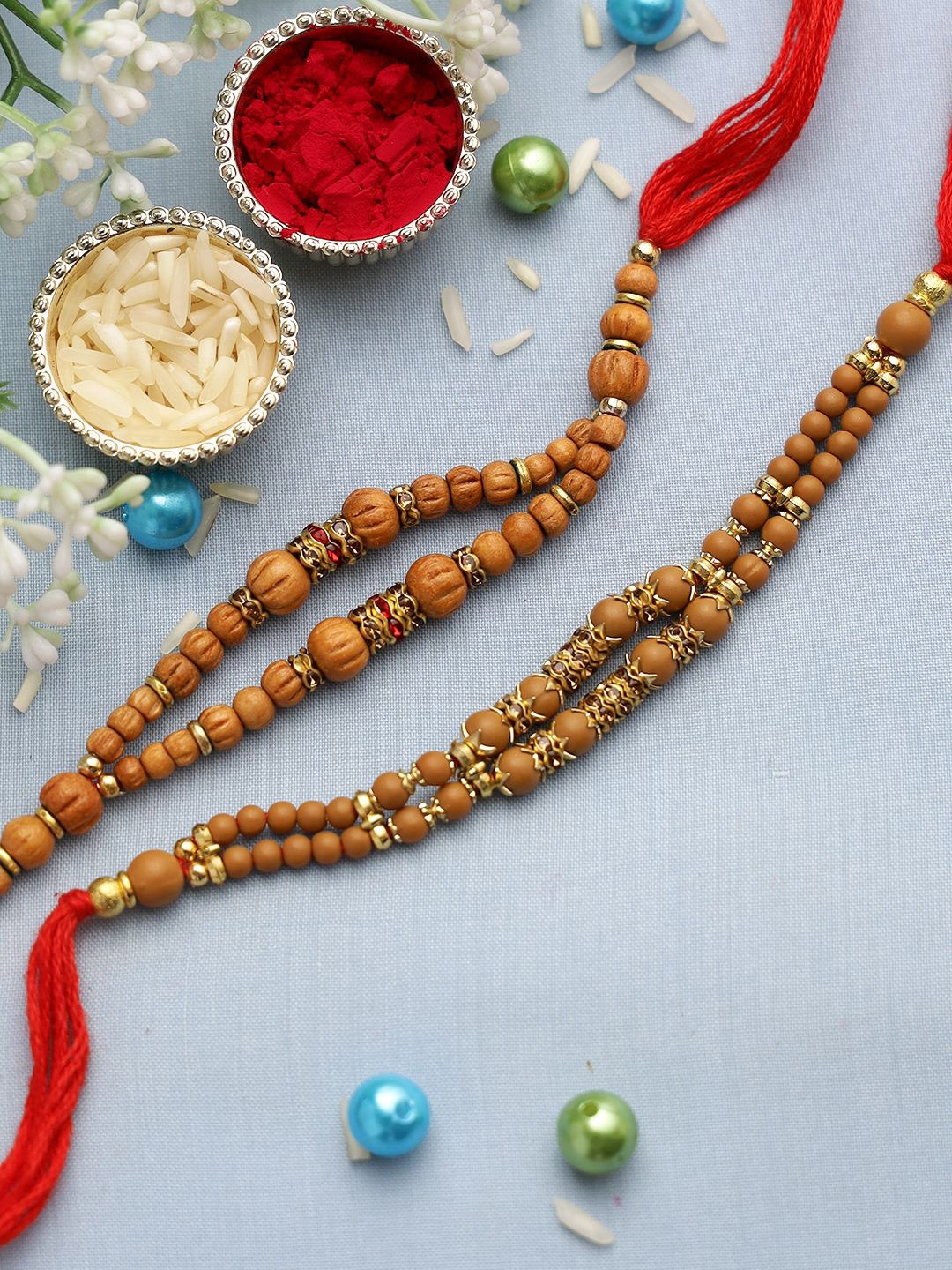 

Aapno Rajasthan Set Of 2 Beaded Rakhis With Rholi Chawal & Greeting Card, Brown
