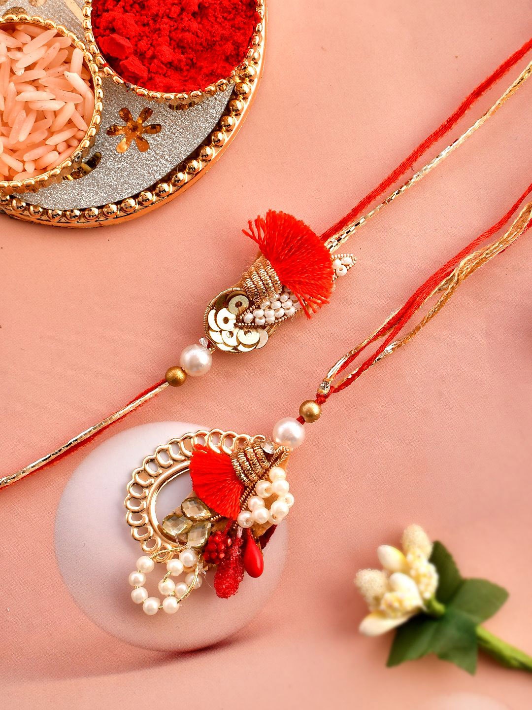 

Aapno Rajasthan Set Of 2 Sequined & Pearl-Beaded Rakhis With Roli Chawal & Greeting Card, Gold