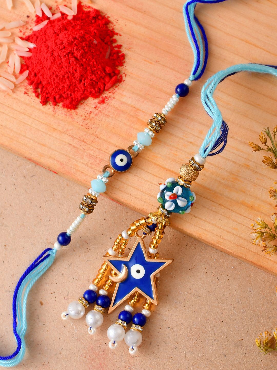 

Aapno Rajasthan Evil Eye Beaded Bhaiya Bhabhi Rakhis With Rholi Chawal, Blue