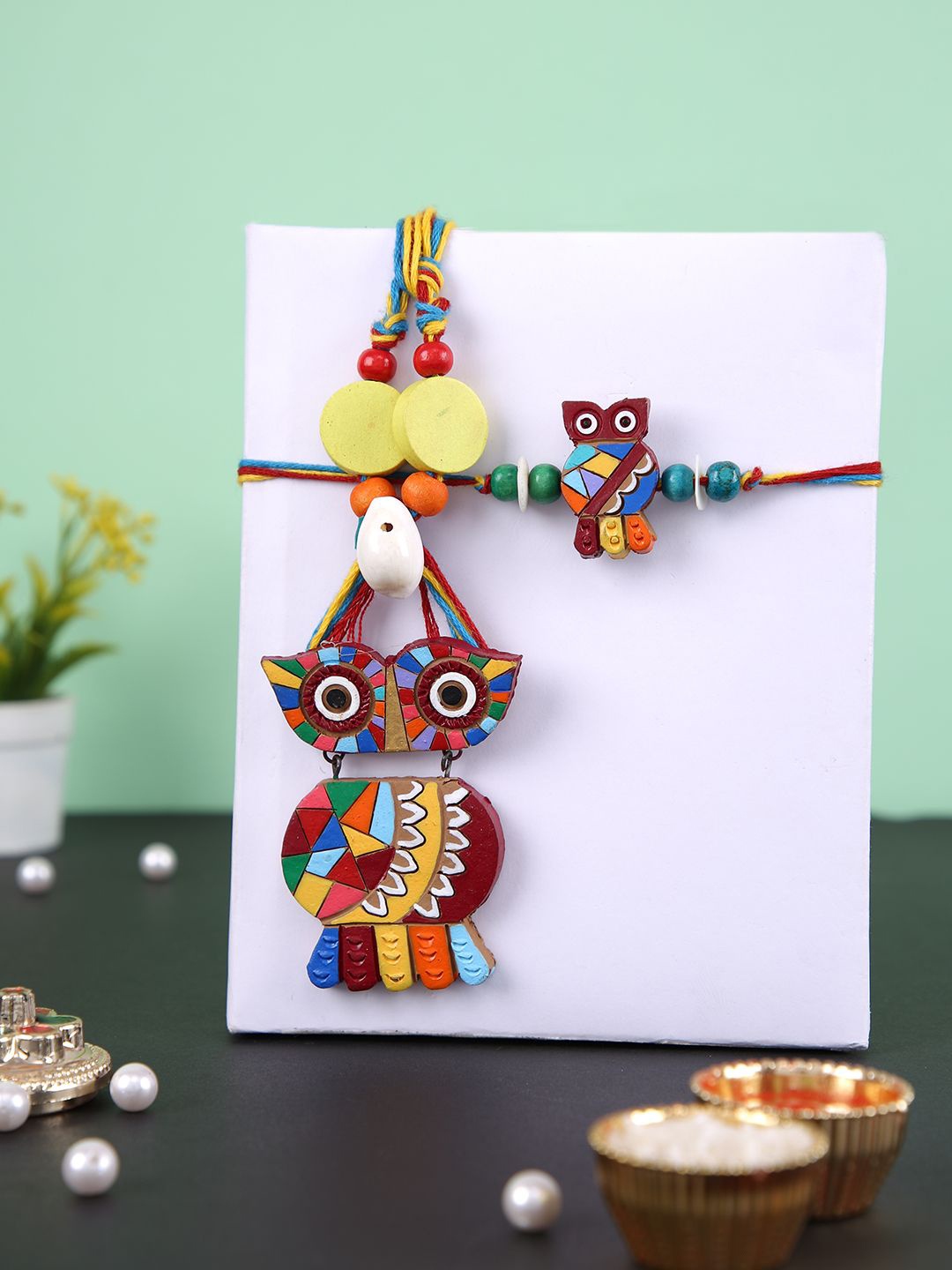 

Aapno Rajasthan Owl with Shell Bhaiya Bhabhi Rakhi With Rholi Chawal & Greeting Card, Brown