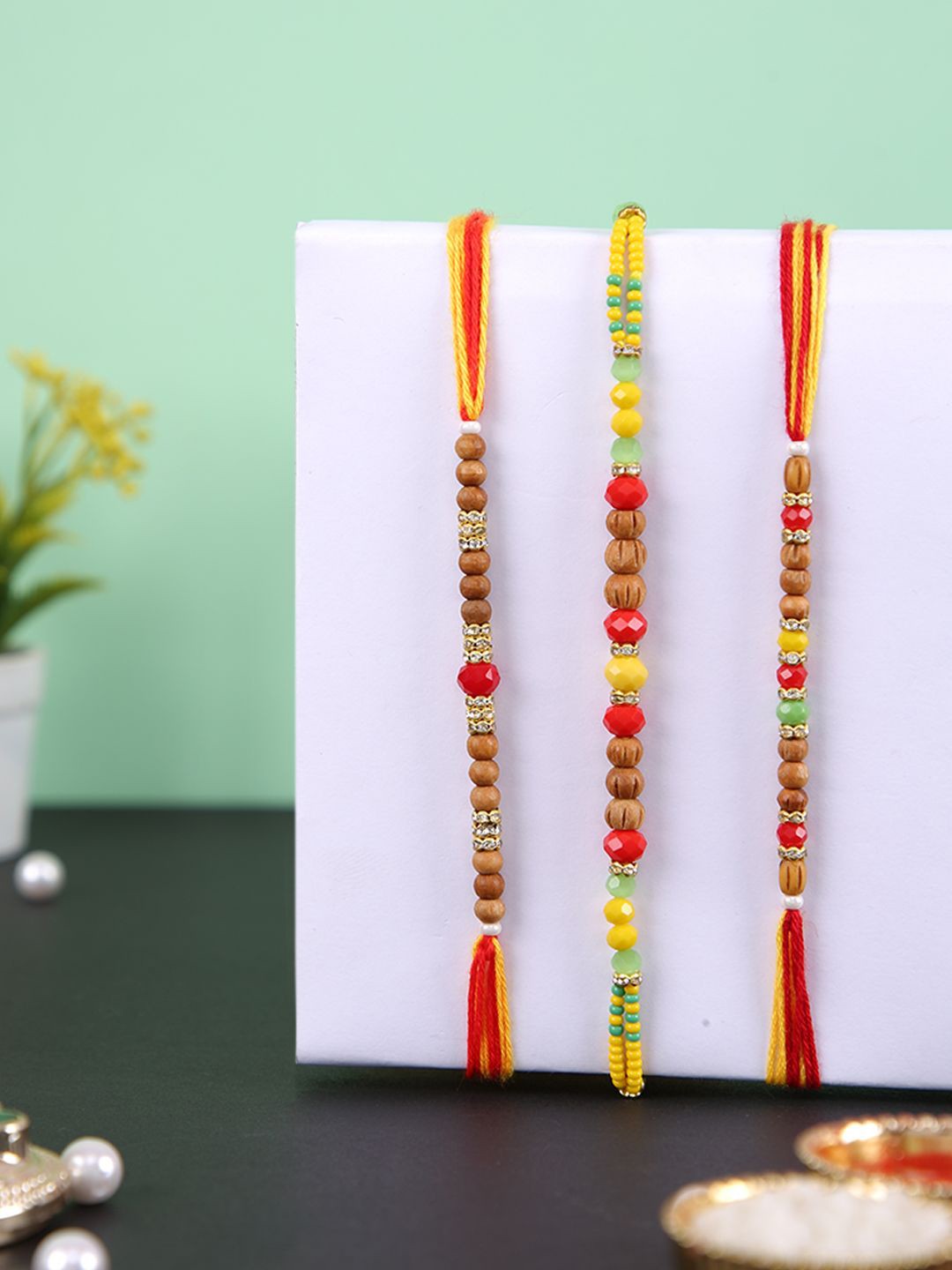 

Aapno Rajasthan Set Of 3 Stone Studded & Beaded Rakhis With Roli Chawal & Greeting Card, Brown
