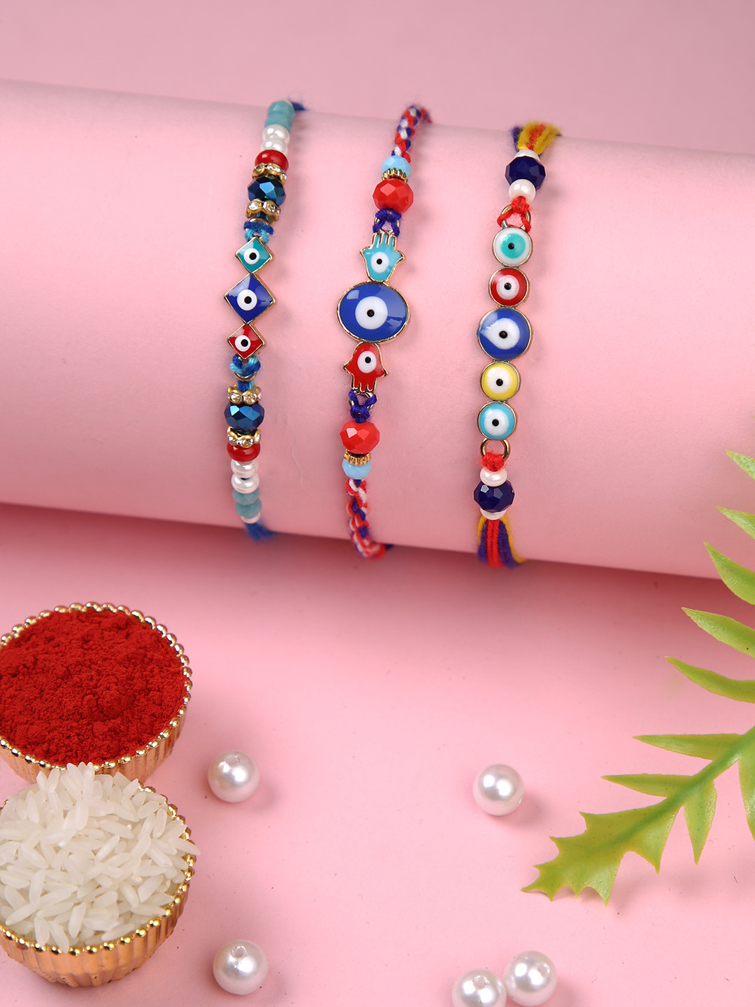 

Aapno Rajasthan Set of 3 Evil Eye Rakhis With Rholi Chawal & Greeting Card, Blue