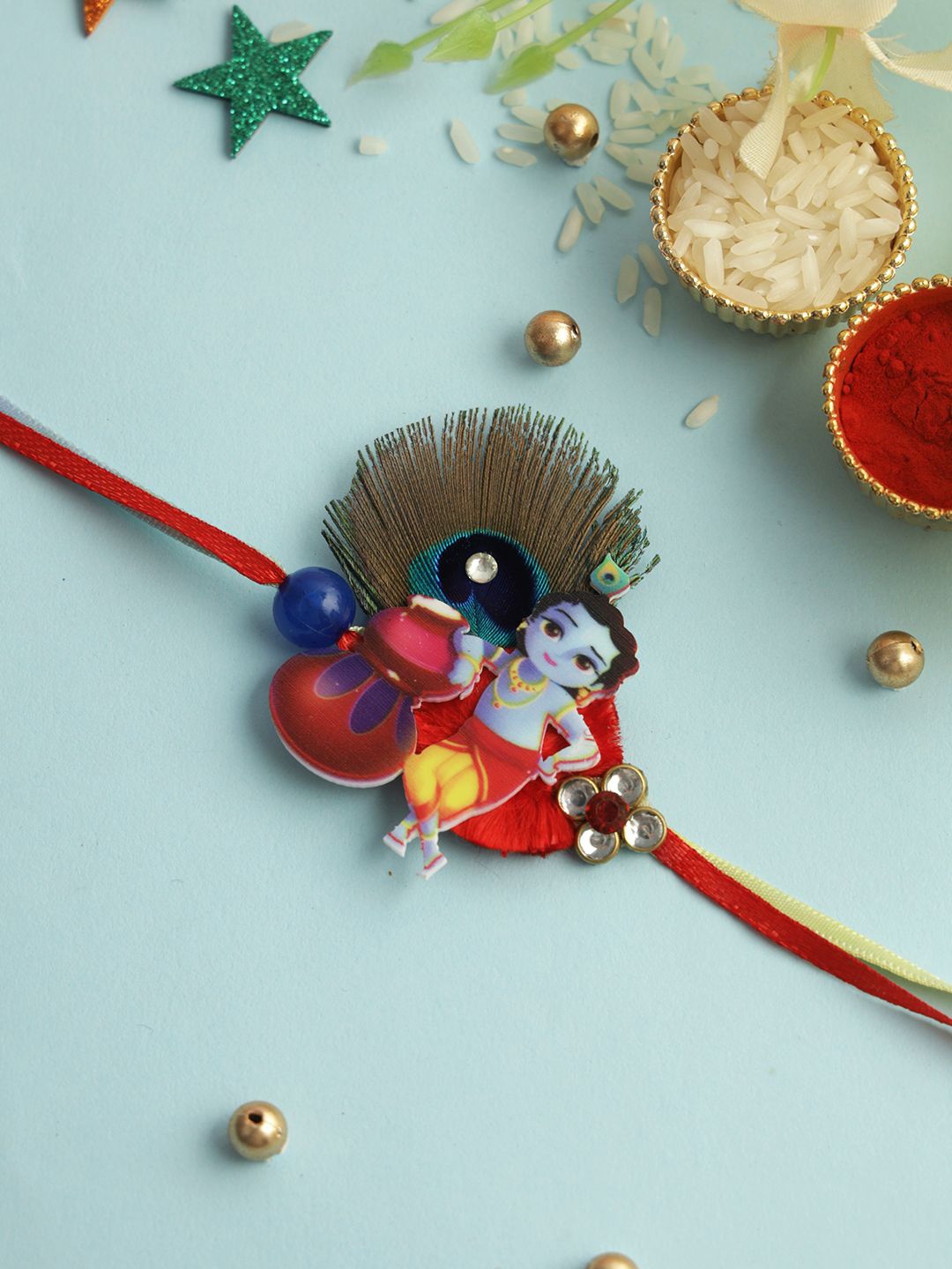

Aapno Rajasthan Little Krishna Playful Rakhi With Roli Chawal & Greeting Card, Red