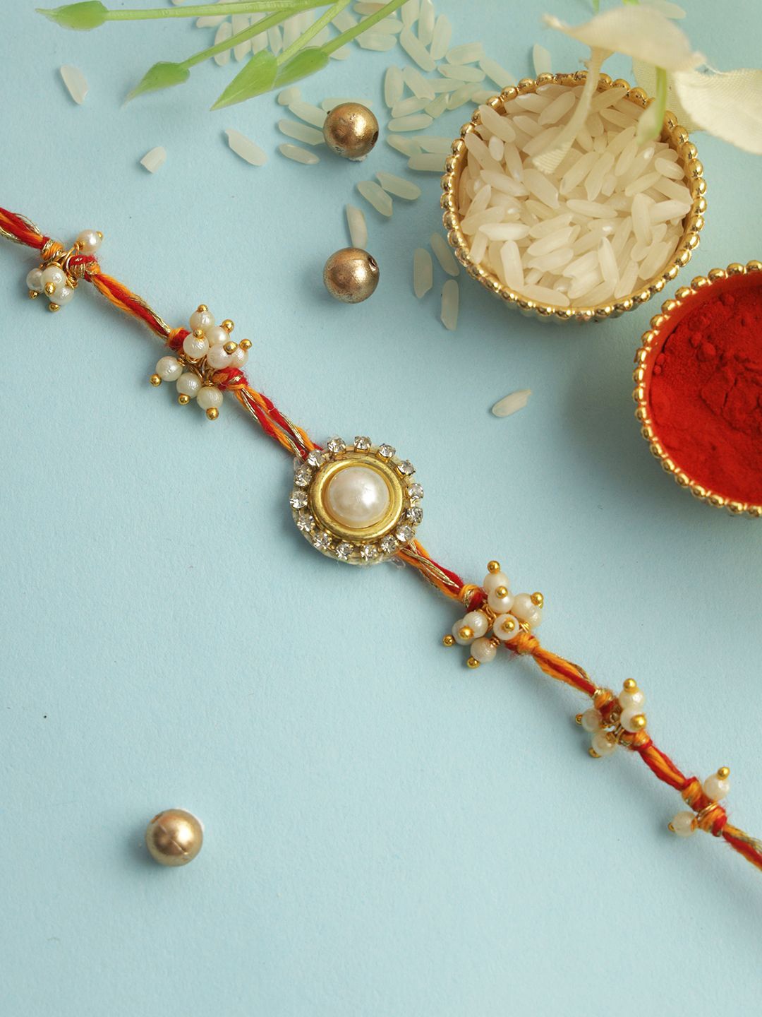 

Aapno Rajasthan Beaded & Stone Studded Rakhi With Roli Chawal & Greeting Card, Cream