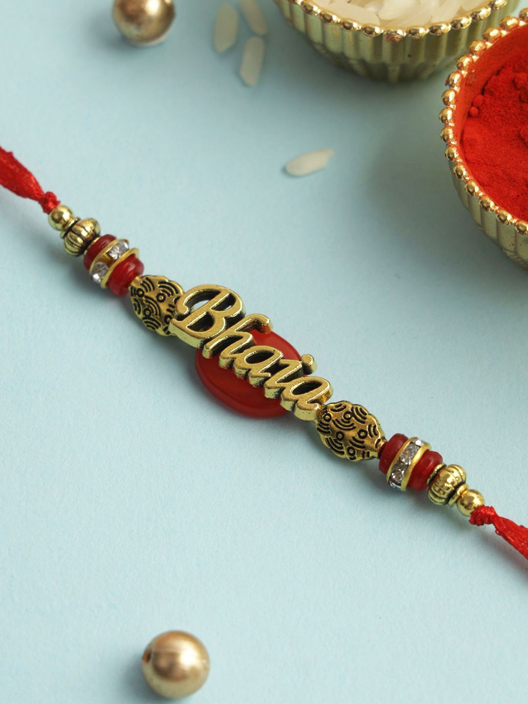 

Aapno Rajasthan Beaded & Stone Studed Rakhi With Roli Chawal & Greeting Card, Gold