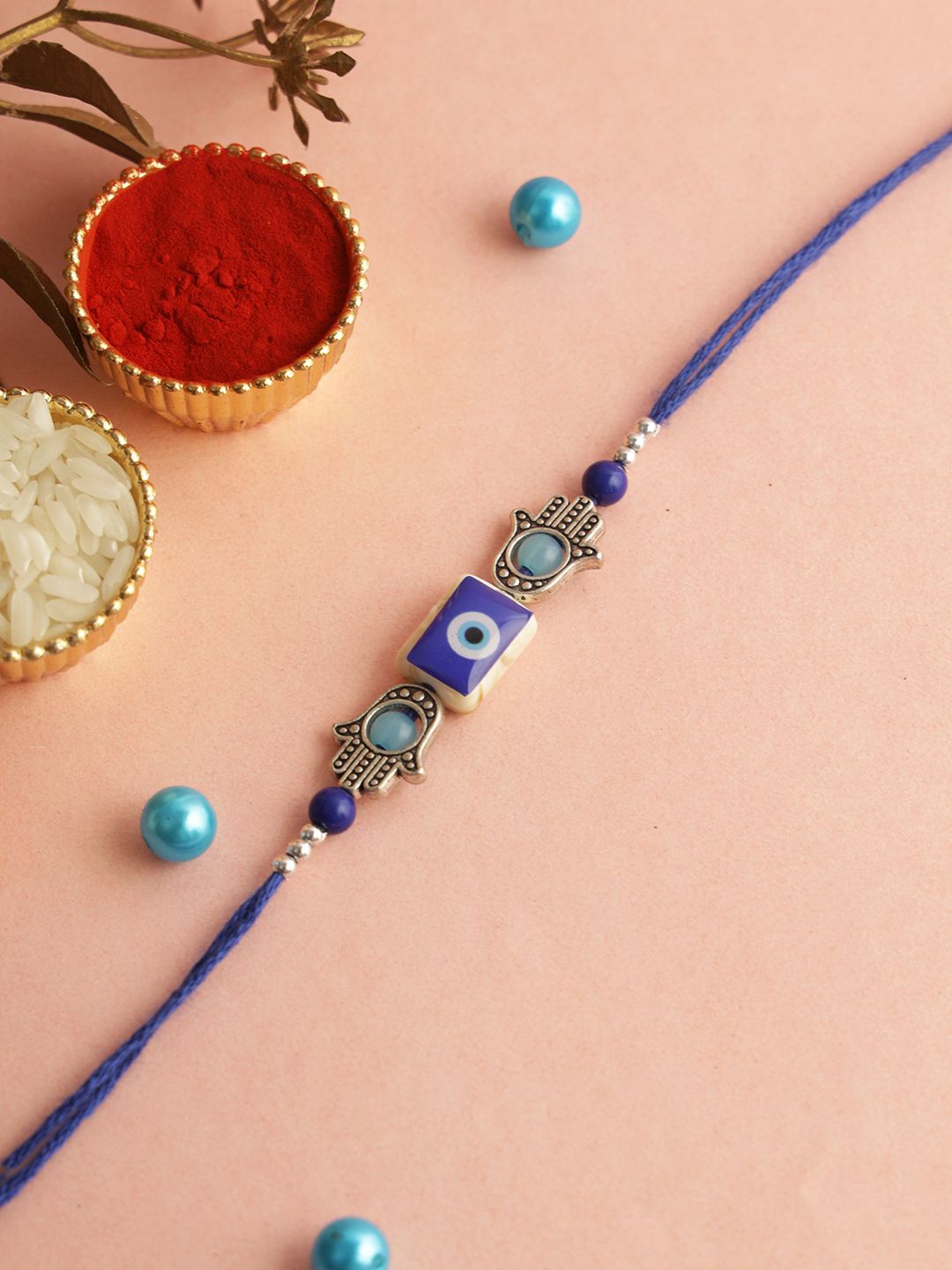 

Aapno Rajasthan Evil Eye Beaded Rakhi With Roli Chawal & Greeting Card, Blue