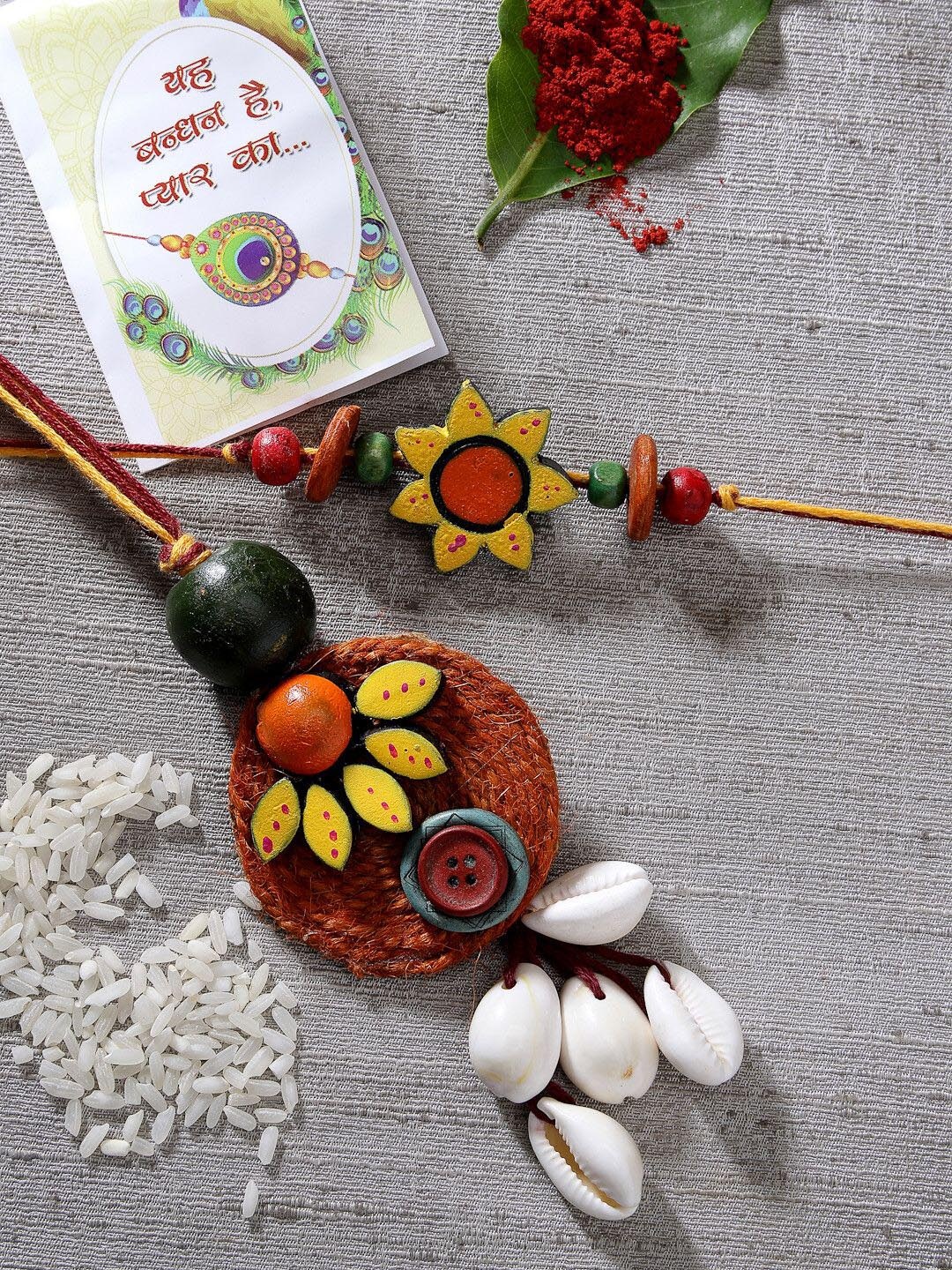 

NVR Set of 2 Thread Rakhis With Chocolate & Greeting Card with Roli Chawal, Red