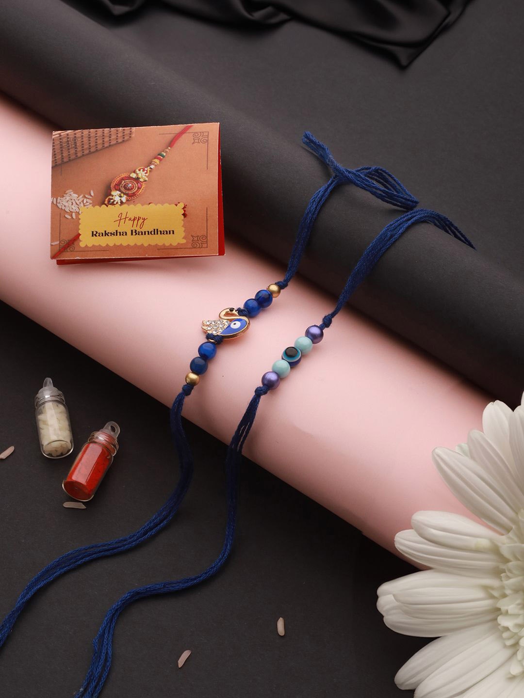 

Saraf RS Jewellery Set Of 2 Evil Eye Crystal Beaded Rakhi With Roli Tilak & Greeting Card, Blue
