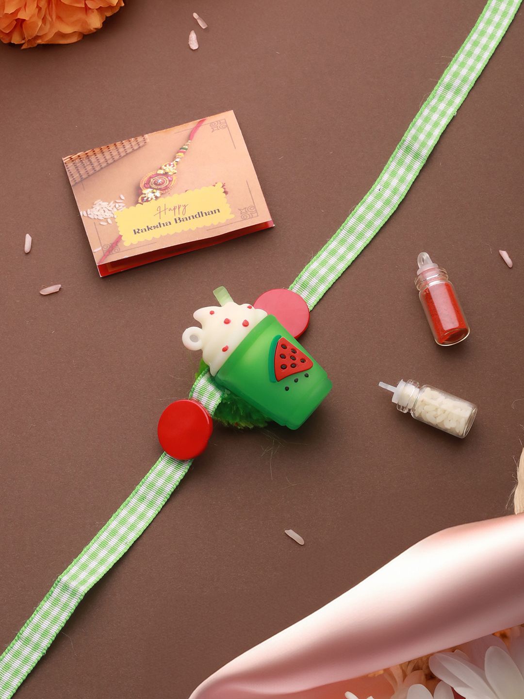 

Saraf RS Jewellery Ice Cream Shape Toy Ribbon Rakhi with Roli Chawal & Greeting Card, Green
