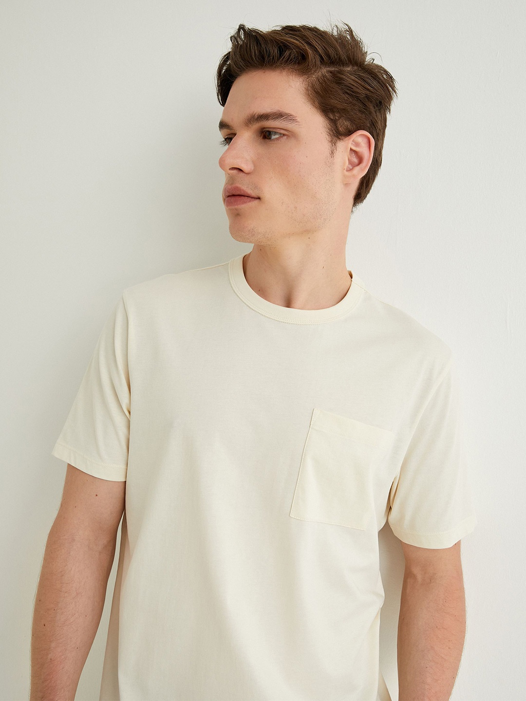 

Koton Men Solid Round Neck Pocket T-shirt, Beige