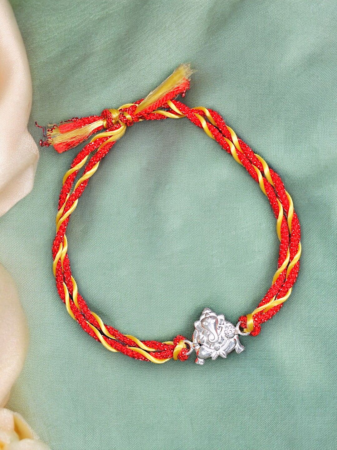 

Taraash 925 Sterling Silver Lord Ganpati Thread Rakhi