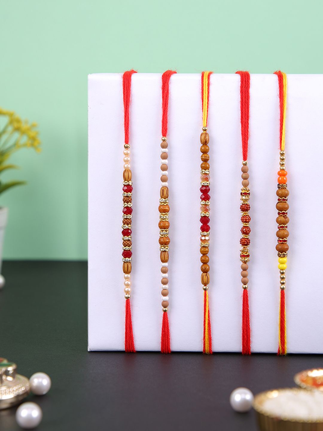 

Aapno Rajasthan Set of 5 Beaded Multistrand Rakhis With Roli Chawal & Greetings Card, Brown