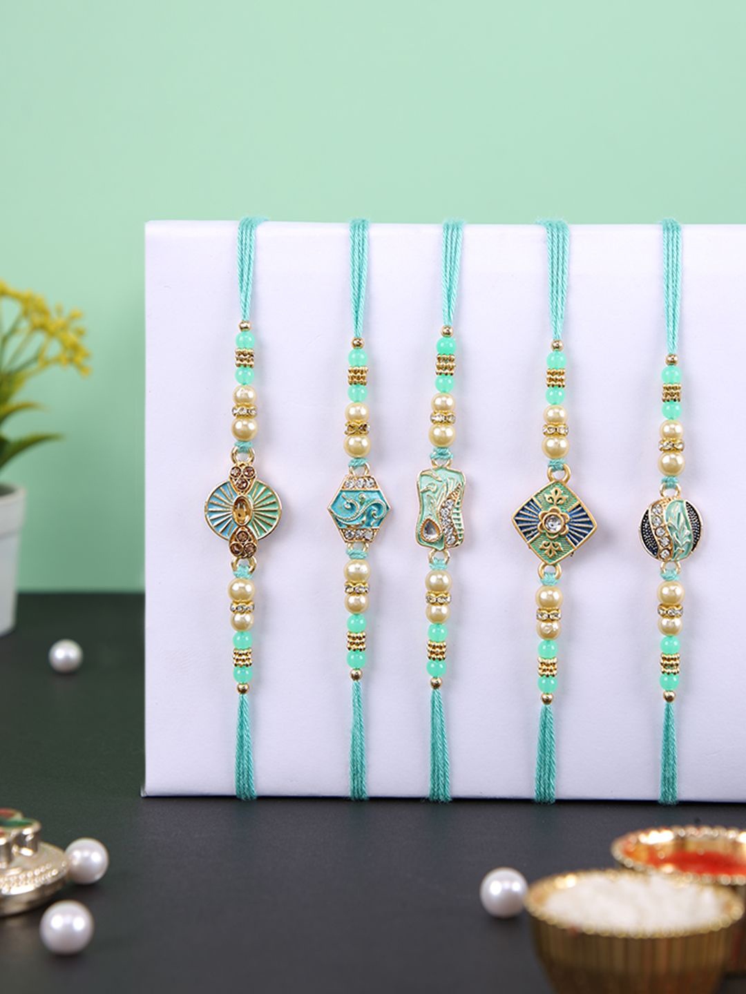 

Aapno Rajasthan Set Of 5 Beaded Rakhis With Roli Chawal & Greeting Card, Blue