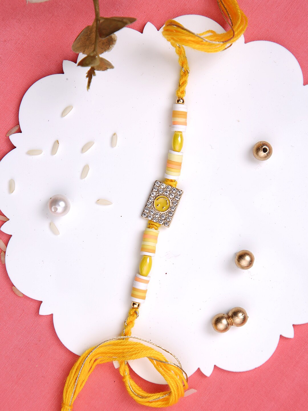 

Aapno Rajasthan Smiley Stone Studded Multistrand Rakhi With Roli Chawal & Greetings Card, Yellow