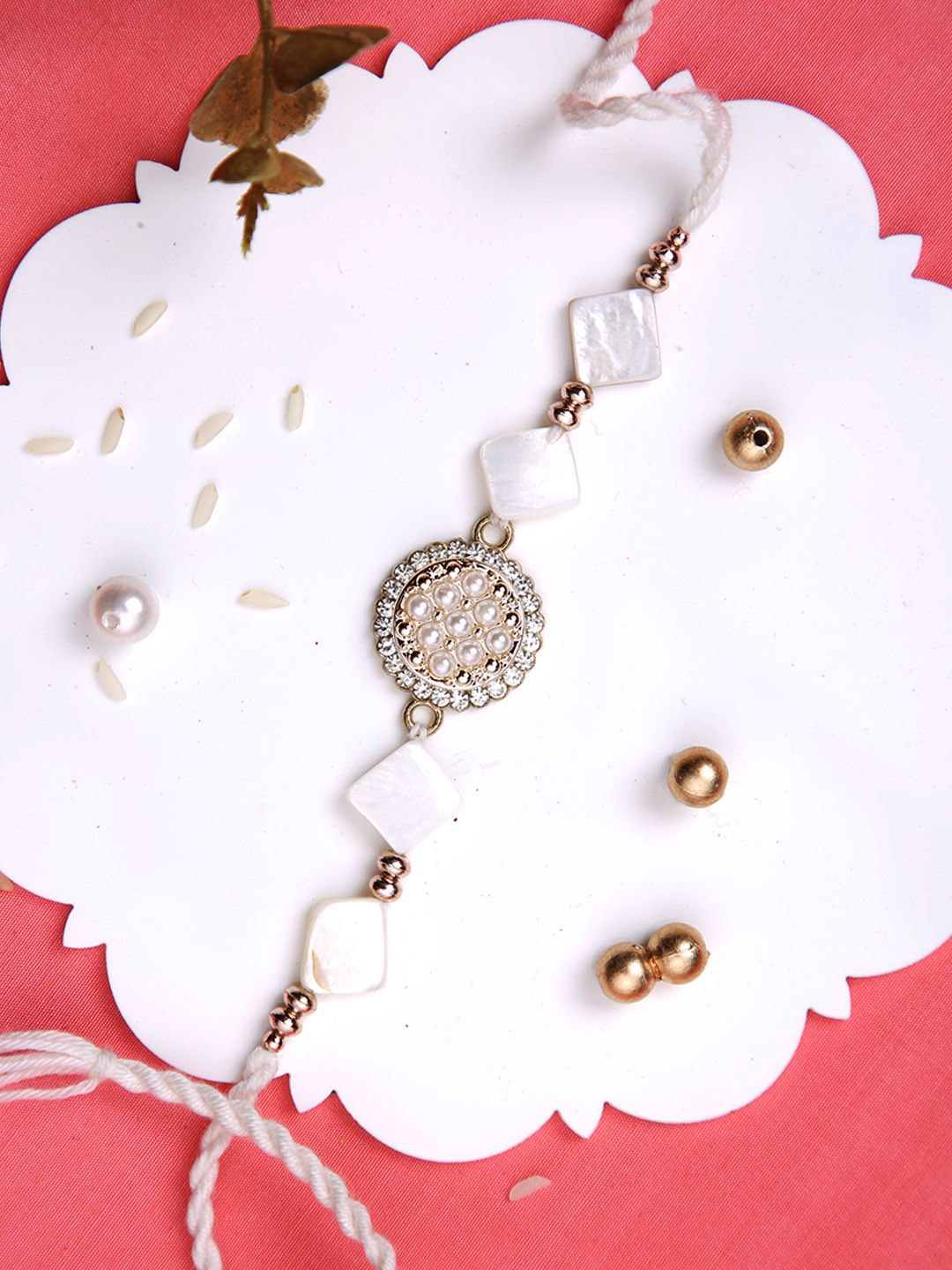 

Aapno Rajasthan Pearl & Stone Studded Multistrand Rakhi With Roli Chawal & Greetings Card, Gold