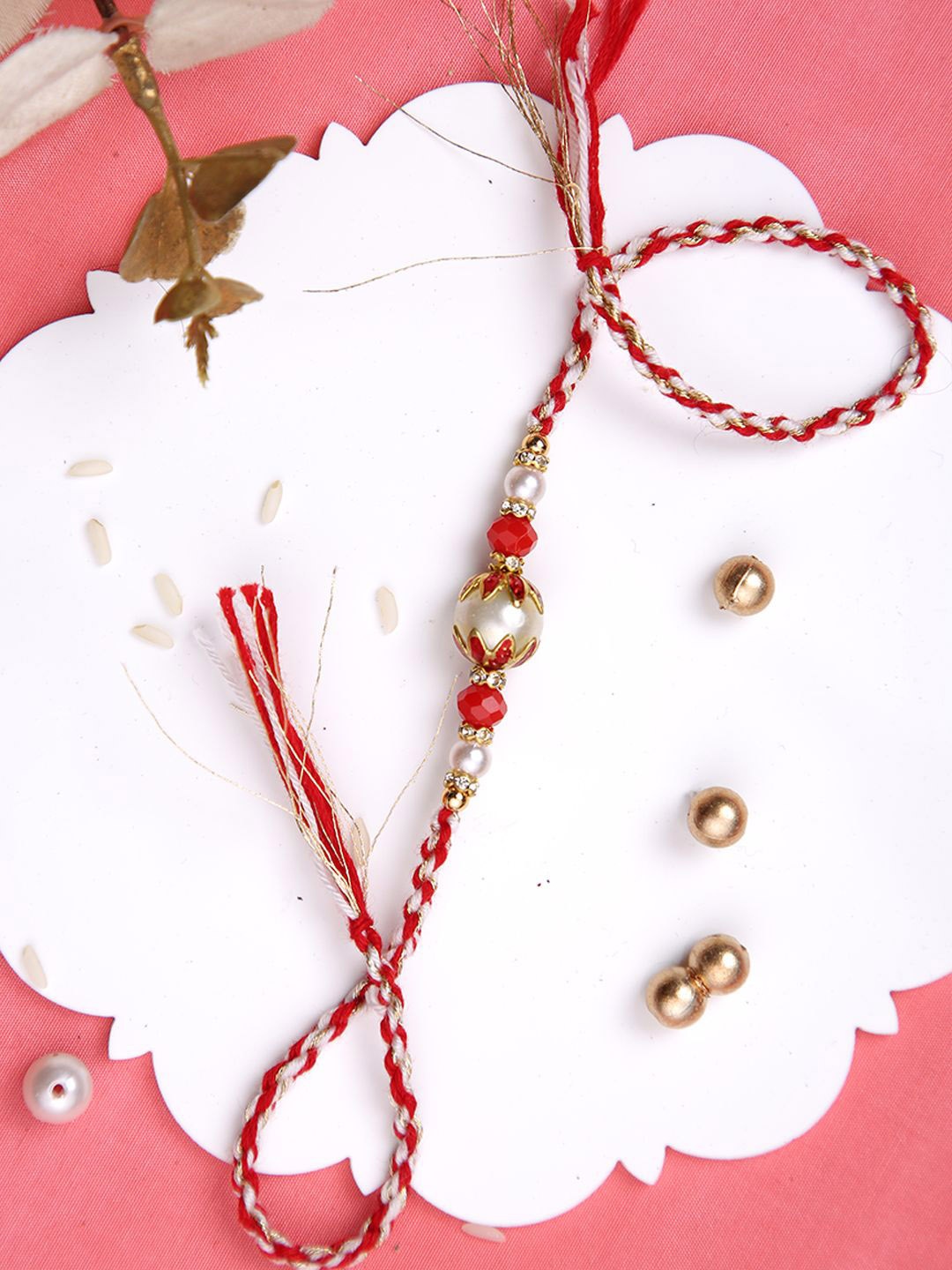 

Aapno Rajasthan Pearl Beaded Twisted Rakhi With Roli Chawal & Greetings Card, Red