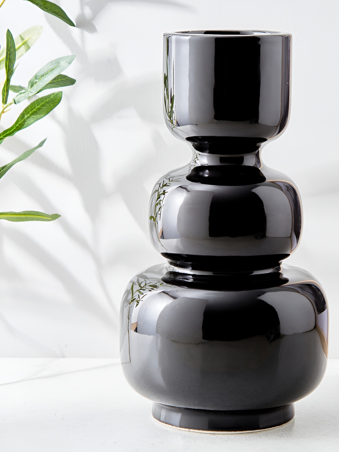 

Home Centre Blanco Black Ceramic Curved Vase