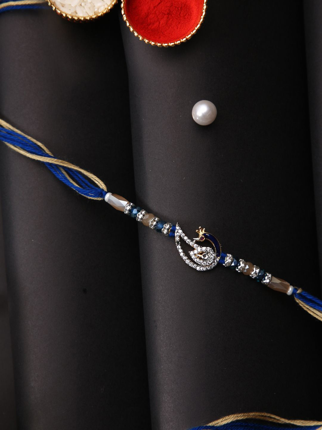 

Aapno Rajasthan Stone Studded Peacock Multistand Rakhi With Roli Chawal & Greetings Card, Silver