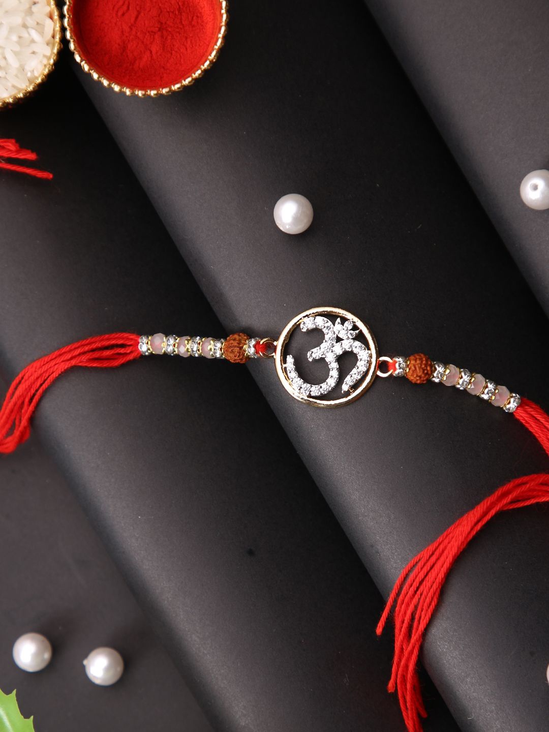 

Aapno Rajasthan Om Stone Studded Multistrand Rakhi With Roli Chawal & Greetings Card, Silver