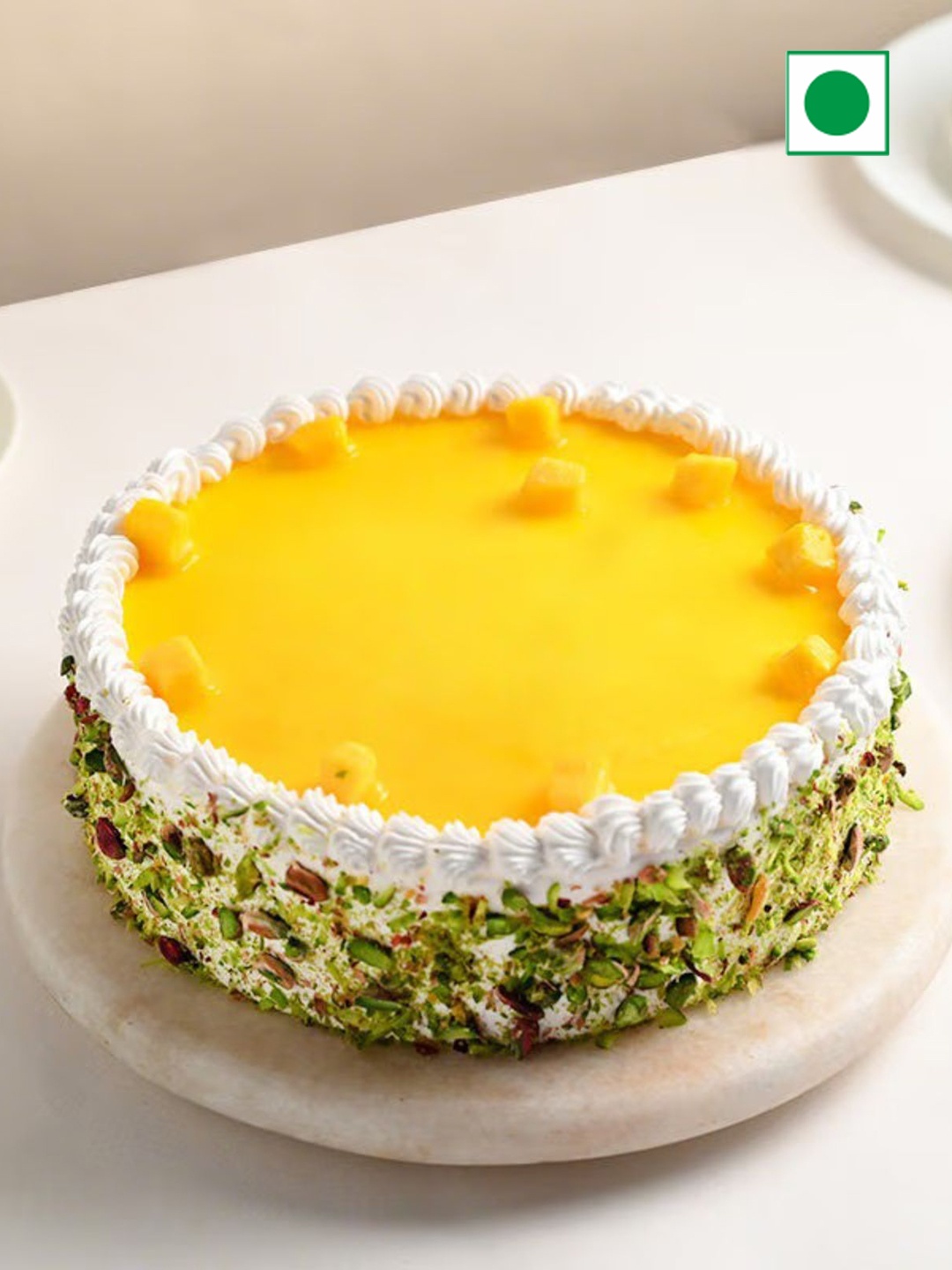

Floweraura Round Shape Mango Pistachio Flavor Eggless Cake -1Kg, Yellow