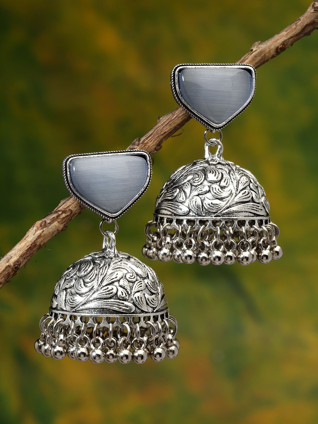 

Sanjog Silver-Plated German Silver Contemporary Artificial Stones Jhumka Earrings