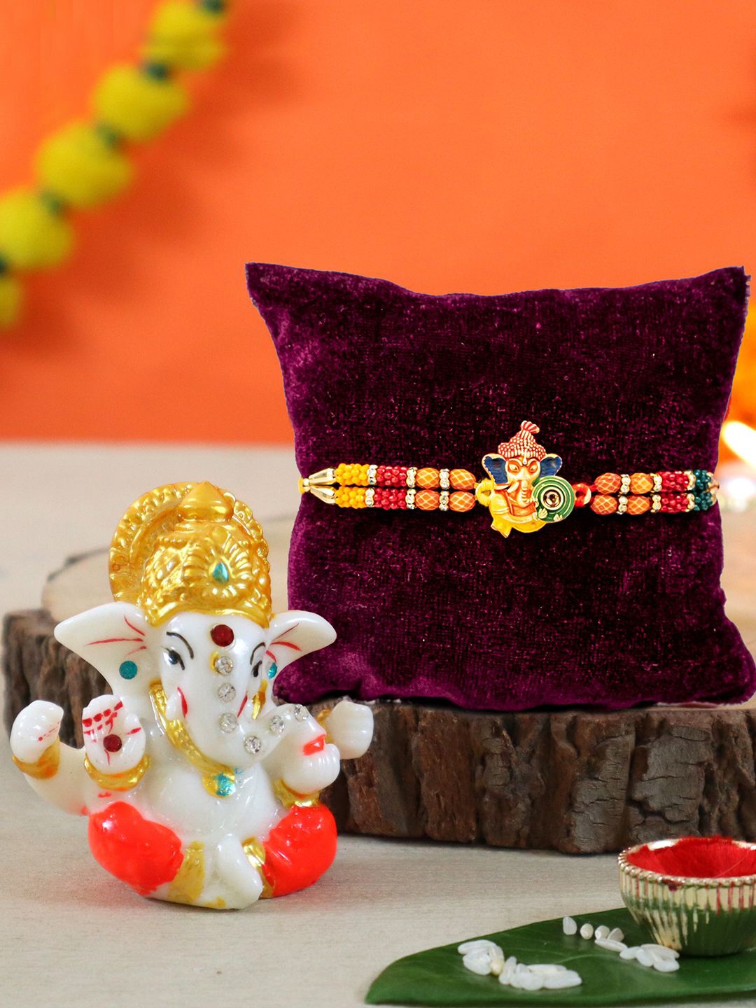 

TIED RIBBONS Set Of 2 Rakhi With Lord Ganesha Idol With Greeting Card and Roli Chawal, Red