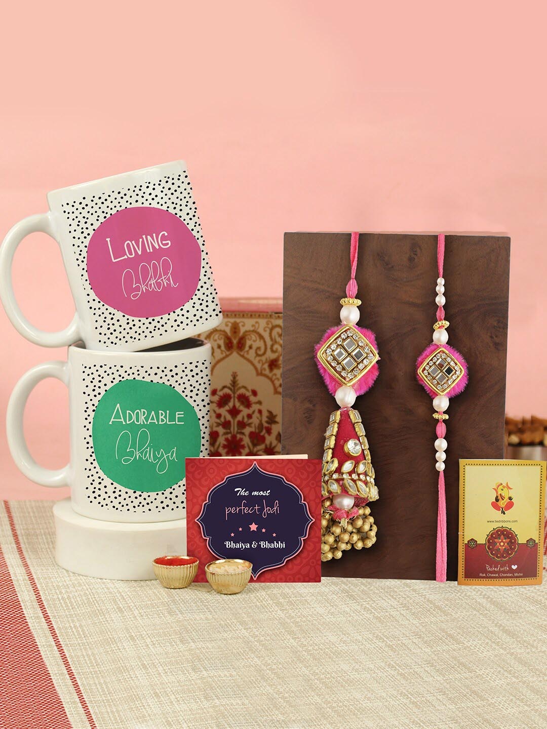 

Tied Ribbons Set of 2 Bhaiya Bhabhi Rakhi, Mugs, Greeting Card & Roli Chawal, White