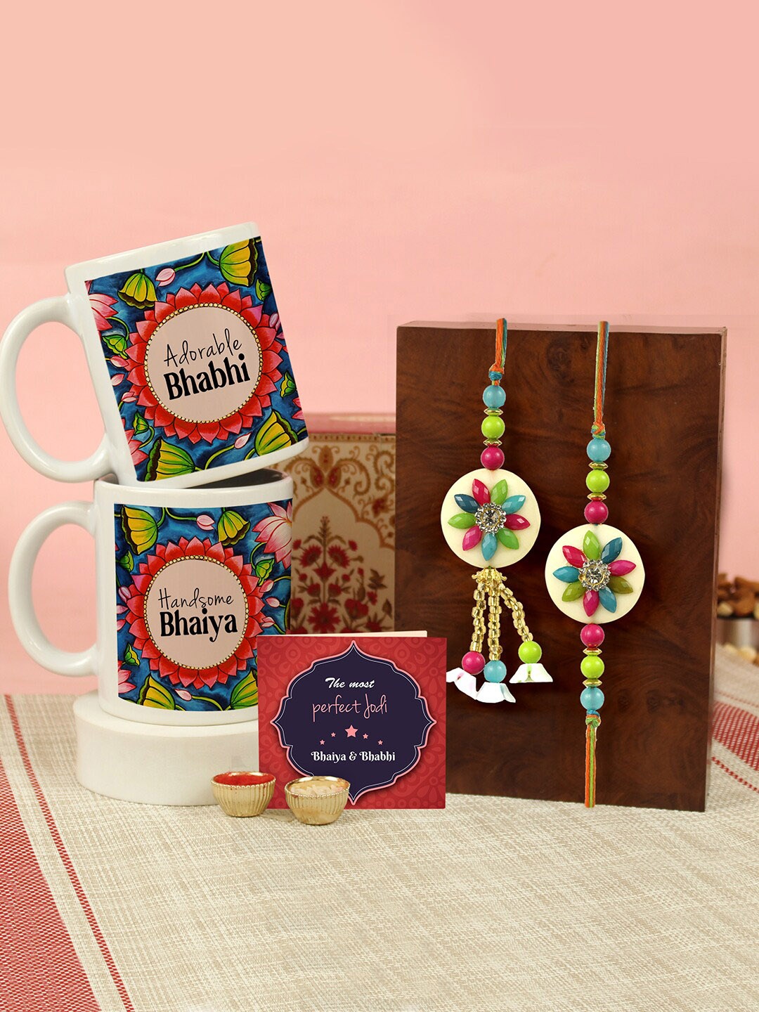 

Tied Ribbons Set of 2 Rakhi, Coffee Mugs, Greeting Card & Roli Chawal Gift Set, Pink