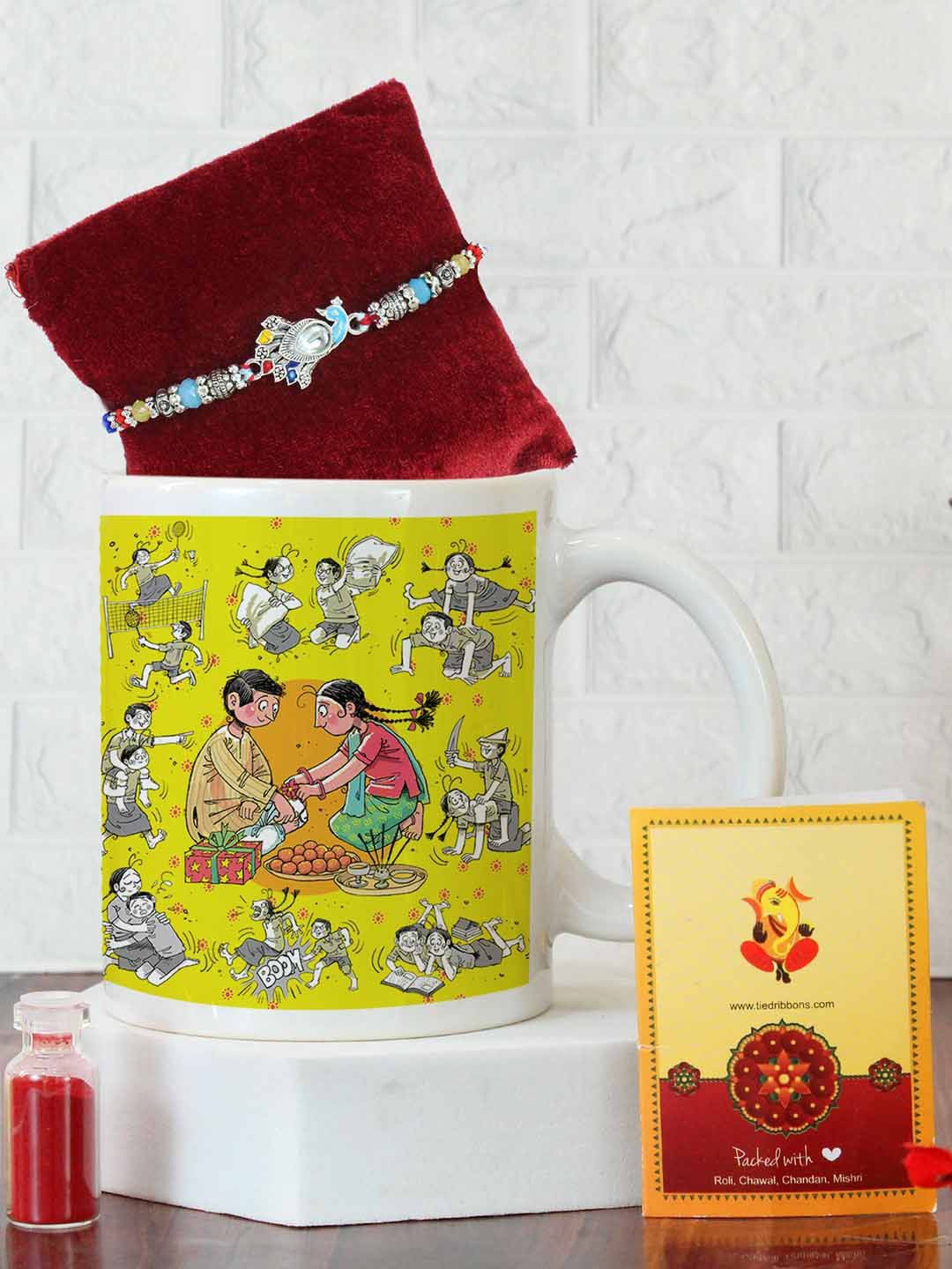

Tied Ribbons Peacock Design Rakhi, Printed Mug, Card & Roli Chawal Gift Set, Blue