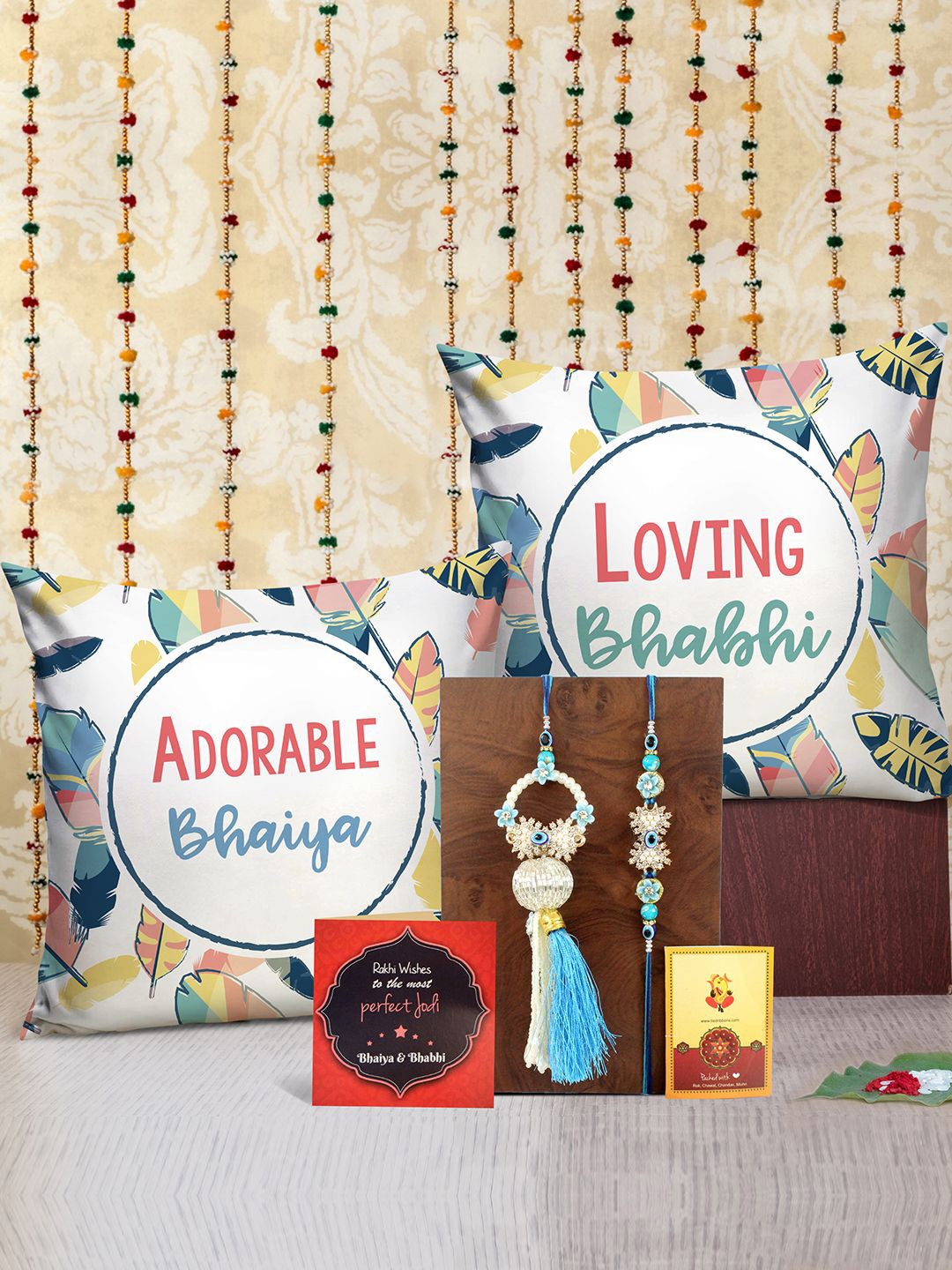 

Tied Ribbons Set of 2 Rakhi, Printed Cushion, Greeting Card & Roli Chawal Gift Set, Beige