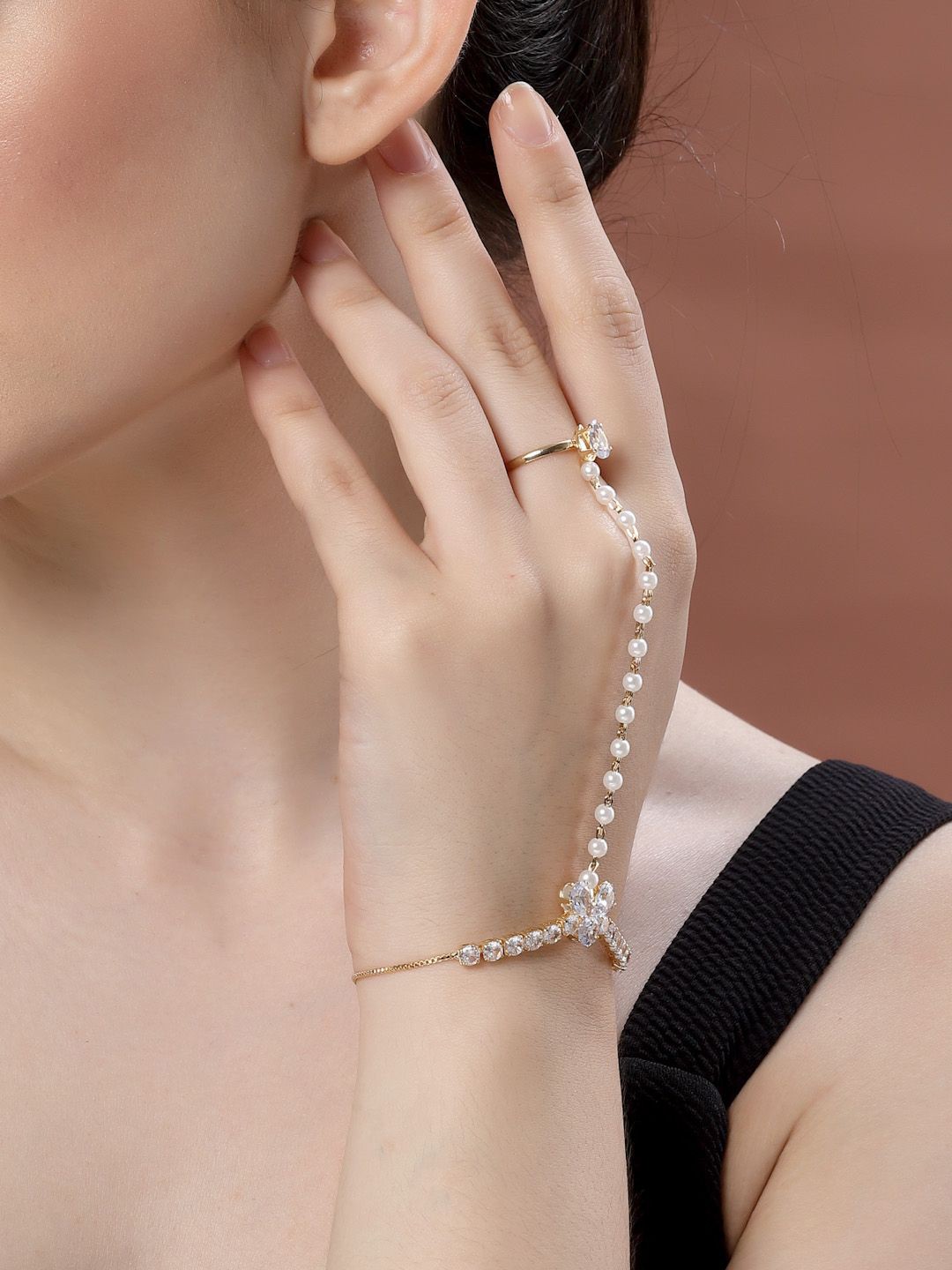 

Sanjog Gold-Plated Crystals & AD Stone Studded Finger Ring Hathphool Pearl Bracelet
