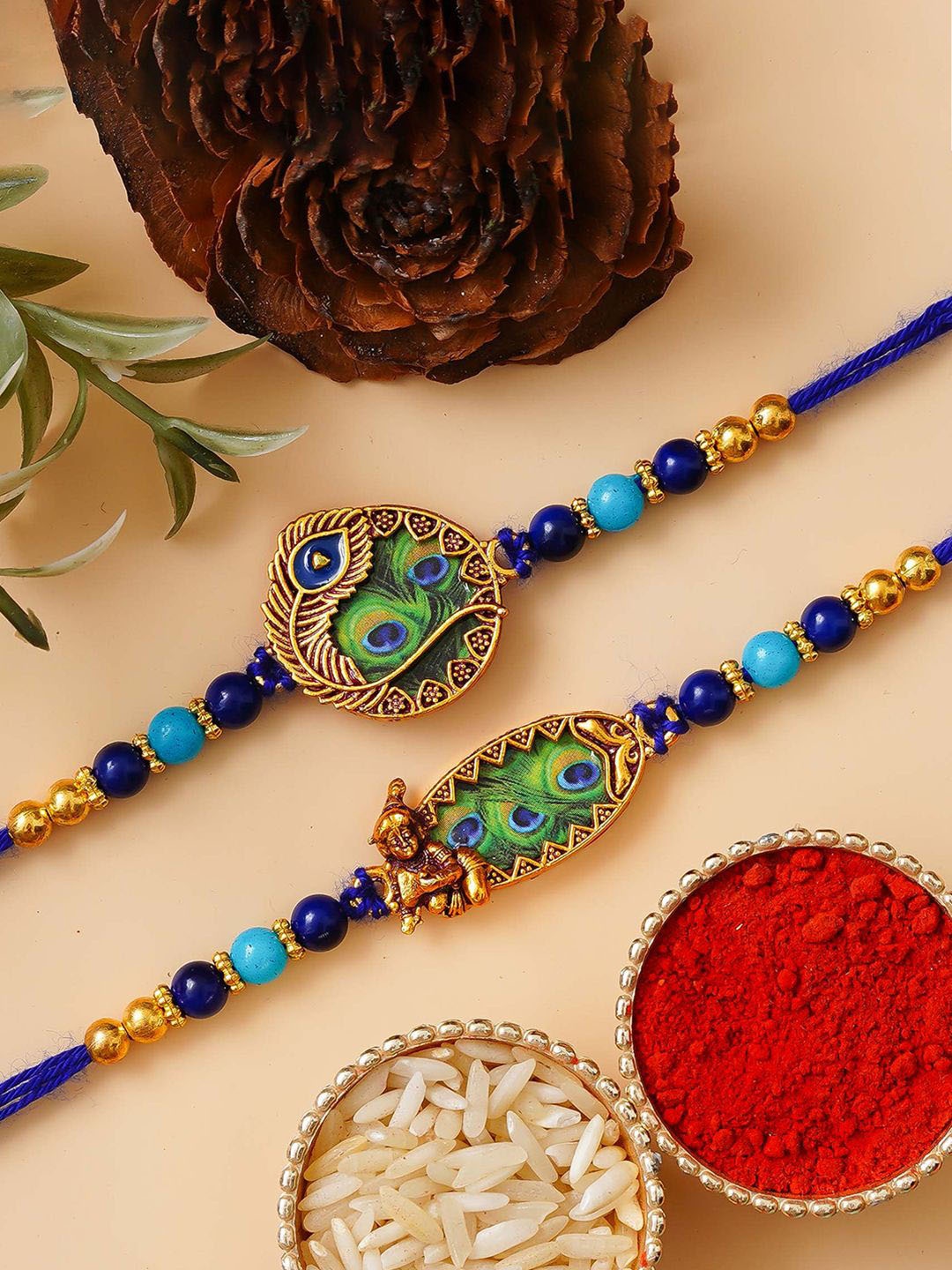 

eCraftIndia Set of 2 Krishna Peacock Feather Designer Rakhis With Roli Chawal, Blue