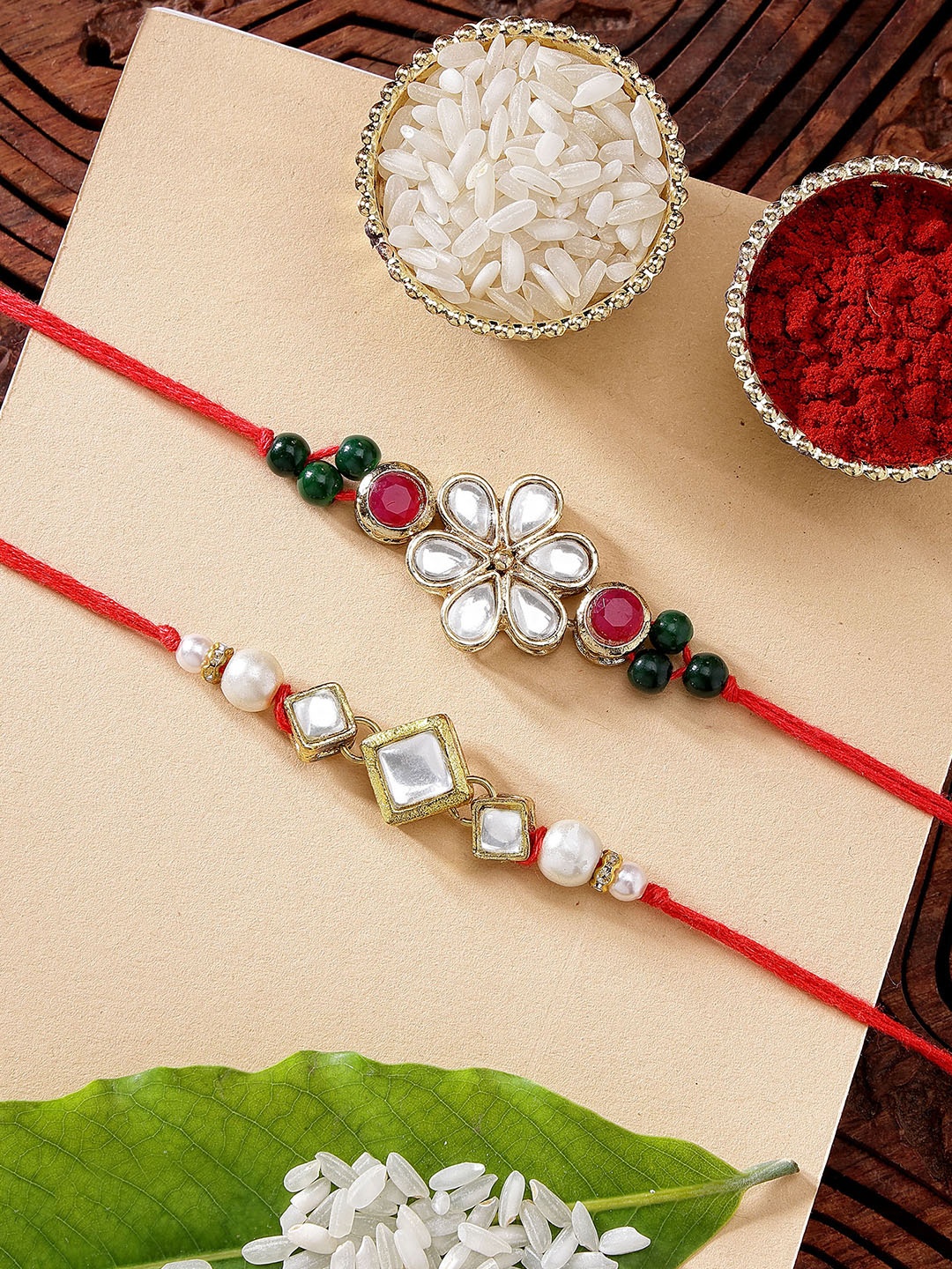 

KARATCART Set of 2 Floral Design Pearl & Kundan Rakhi with Roli & Chawal, Red