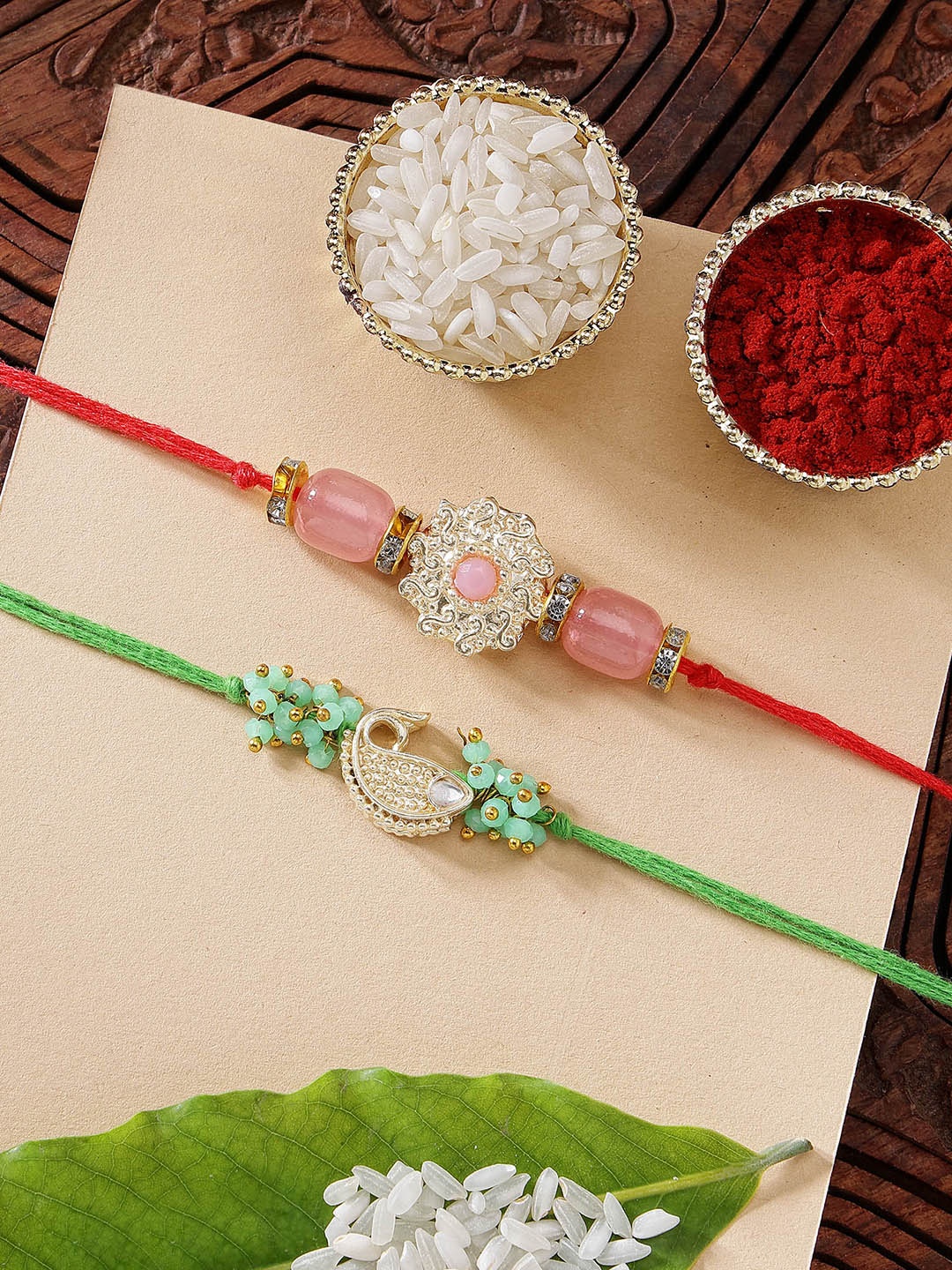 

KARATCART Set of 2 Pink Stone & Green Fish Kundan Rakhi with Roli & Chawal, Gold