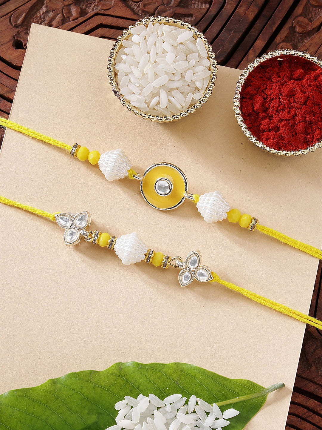 

KARATCART Set of 2 Yellow Meena Evil Eye Kundan Rakhi with Roli & Chawal