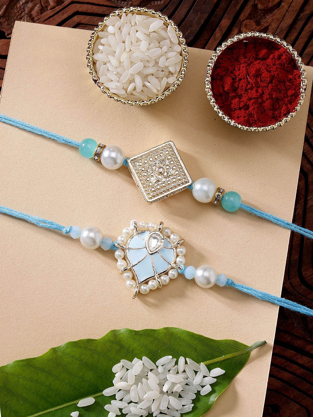 

KARATCART Set of 2 Blue Meena Heart Shape Kundan Rakhi with Roli & Chawal
