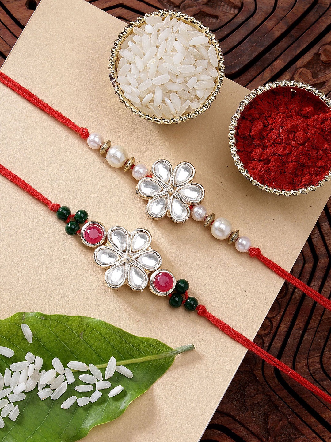 

KARATCART Set of 2 Floral Design Pearl & Kundan Rakhi with Roli & Chawal, Red