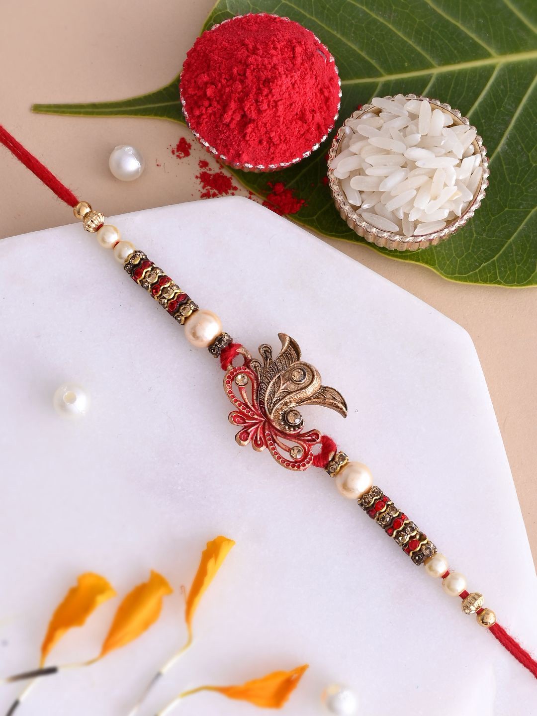 

Aapno Rajasthan Stone Studded & Beaded Ganapati Rakhi With Roli Chawal & Greeting Card, Gold
