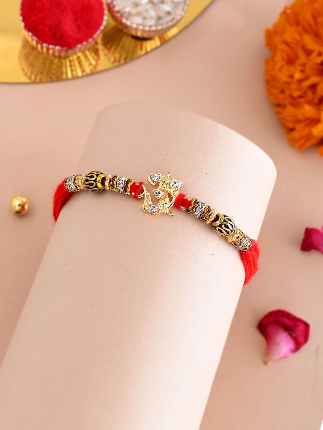 

Aapno Rajasthan Stone Studded & Beaded Om Motif Rakhi With Roli Chawal & Greeting Card, Gold
