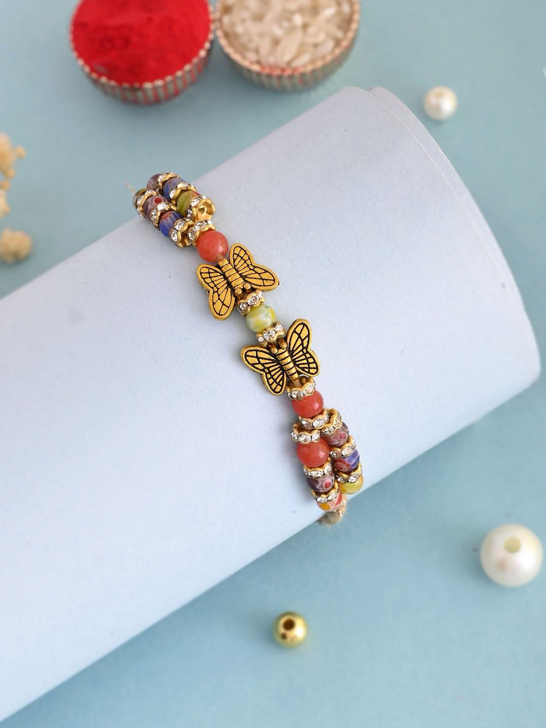 

Aapno Rajasthan Beaded & Stone Studded Rakhi With Roli Chawal & Greeting Card, Gold