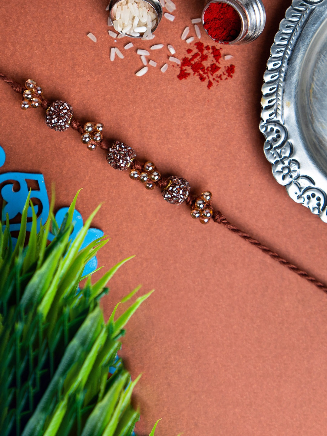 

Phirki Studio Beaded Rakhi With Roli Chawal, Brown
