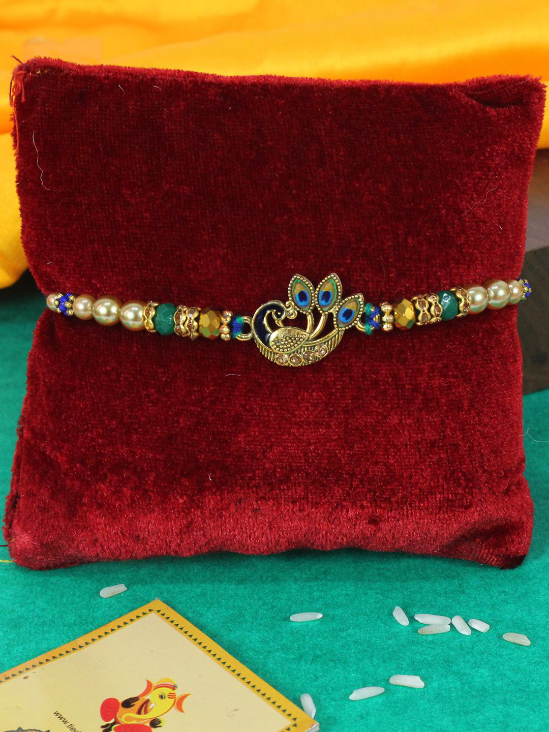 

TIED RIBBONS Peacock Thread Rakhi with Card & Roli Chawal, Blue