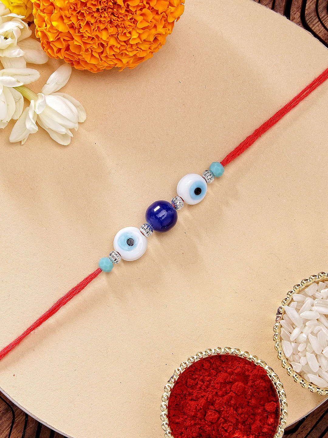 

KARATCART Blue Bead Evil Eye Rakhi with Roli & Chawal, Red