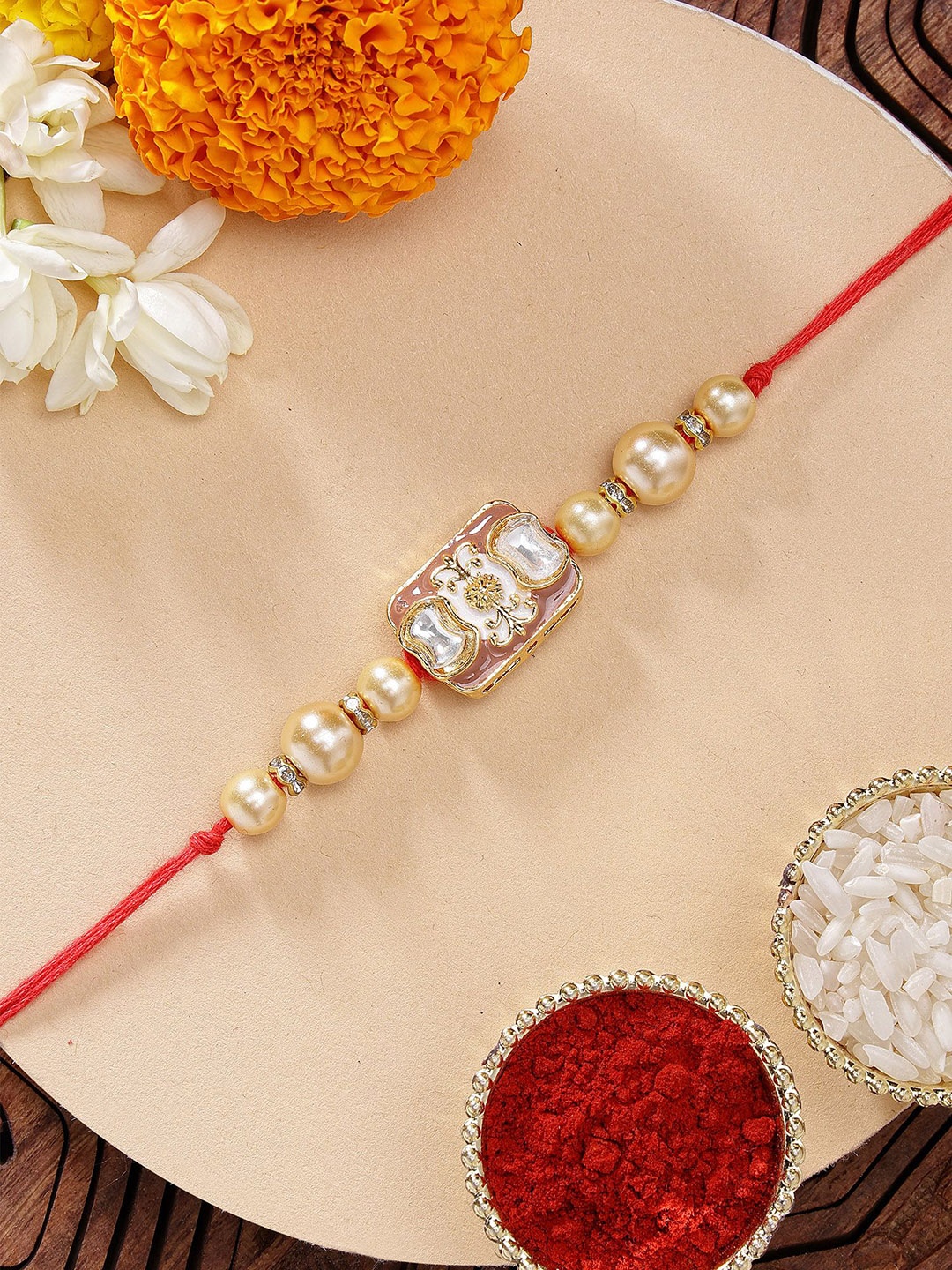 

KARATCART Brown Meena Golden Pearl Kundan Rakhi with Roli & Chawal, Gold